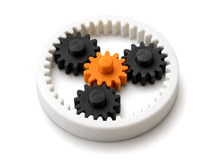 Planetary-gear fidget with an orange sun gear and black planet gears
