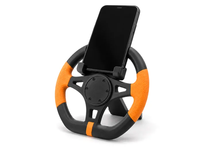 Racing-wheel phone stand holding a phone